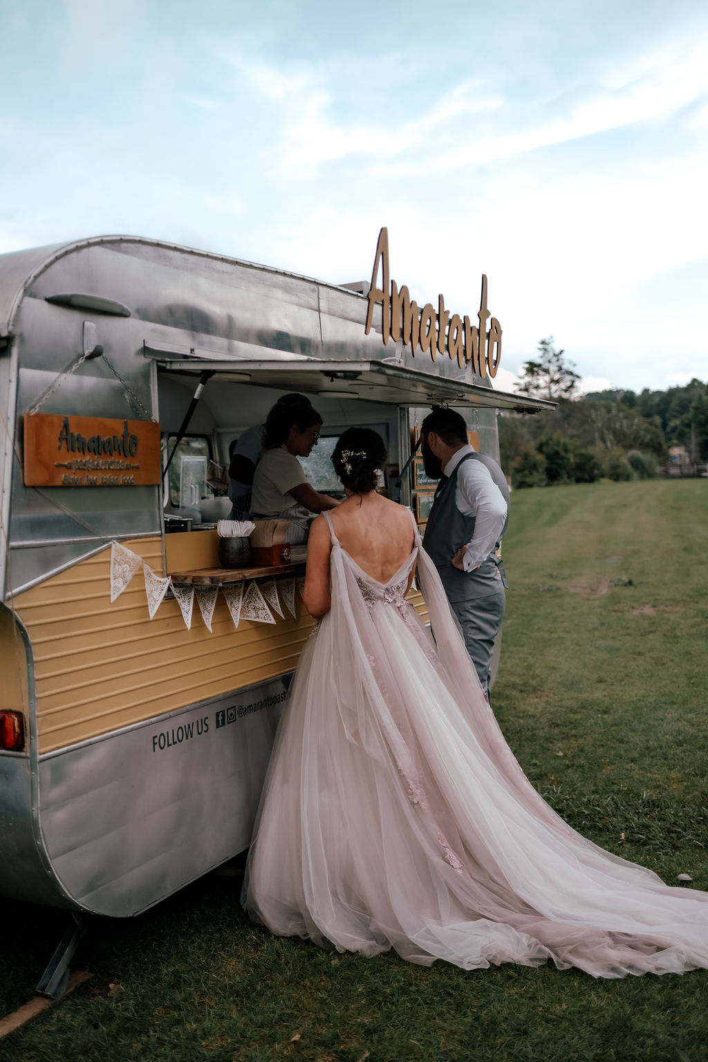 Andrew and Laura ordering fresh pasta from the Amaranto food truck at their Waterfall Farm wedding in Kaukapakapa