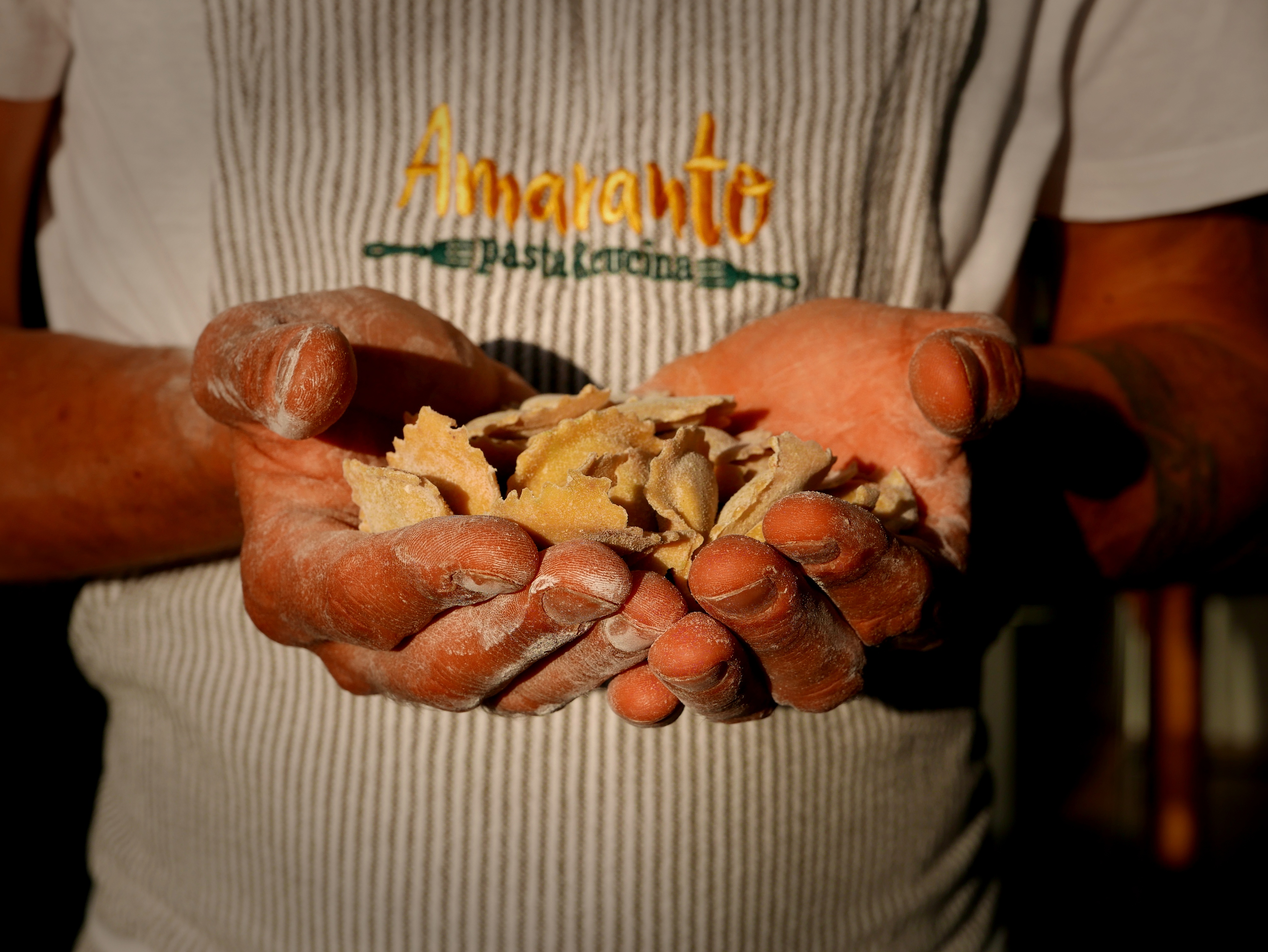 Amaranto chef wearing apron, ready to cook gluten-free Italian pasta