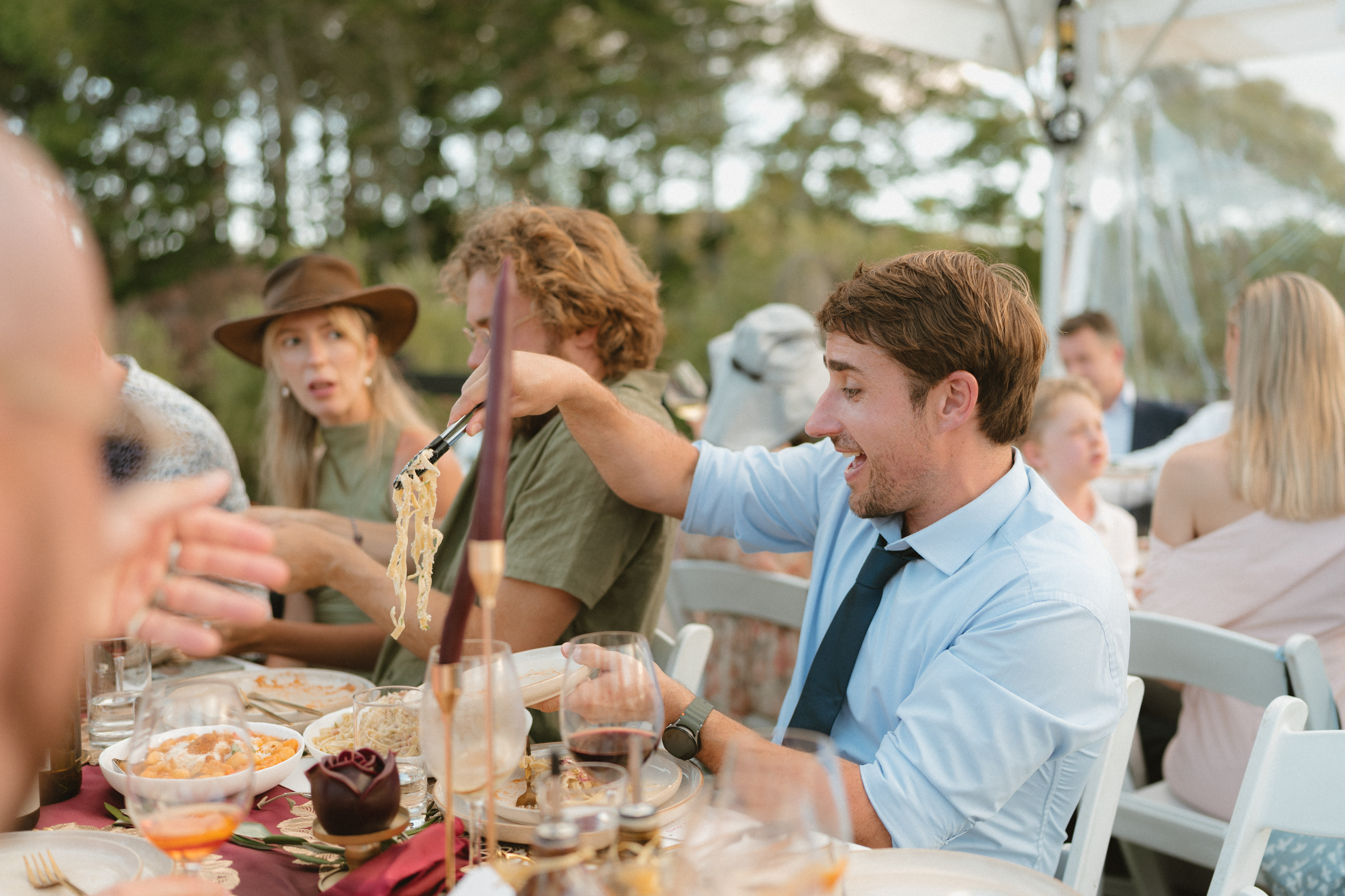 Guests enjoying gluten-free Italian pasta at an Amaranto catered wedding in Northland