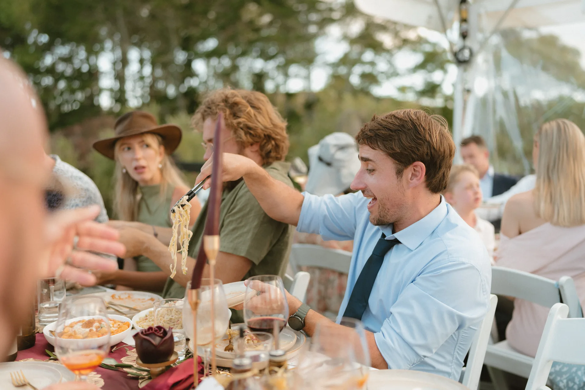 Guests enjoying gluten-free Italian pasta at an Amaranto catered wedding in Northland