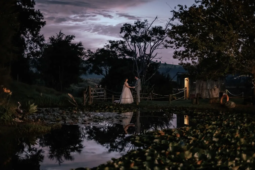 The lily pond at Waterfall Farm reflecting the violet dusk sky at the end of Andrew and Laura's wedding evening