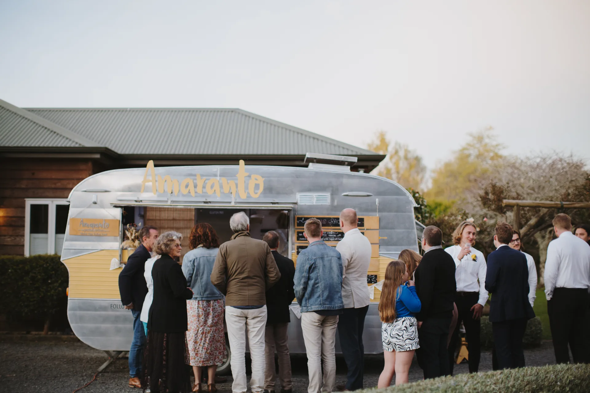 The Amaranto vintage food truck caravan set up for a private dining event in Auckland CBD, with tables dressed for dinner inside an urban venue