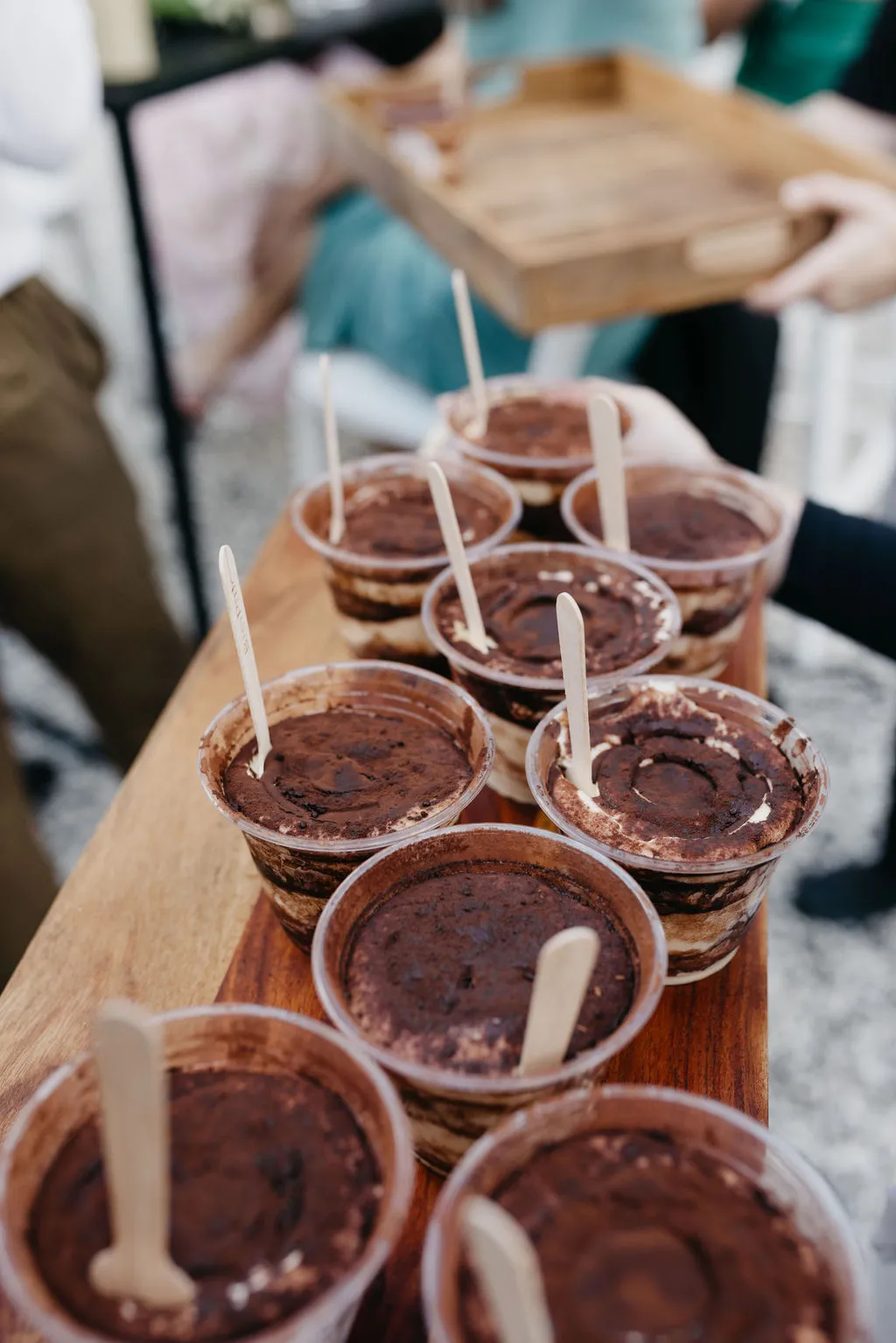Tiramisu cups arranged on a wooden board at Chloe and Mitchell's wedding
