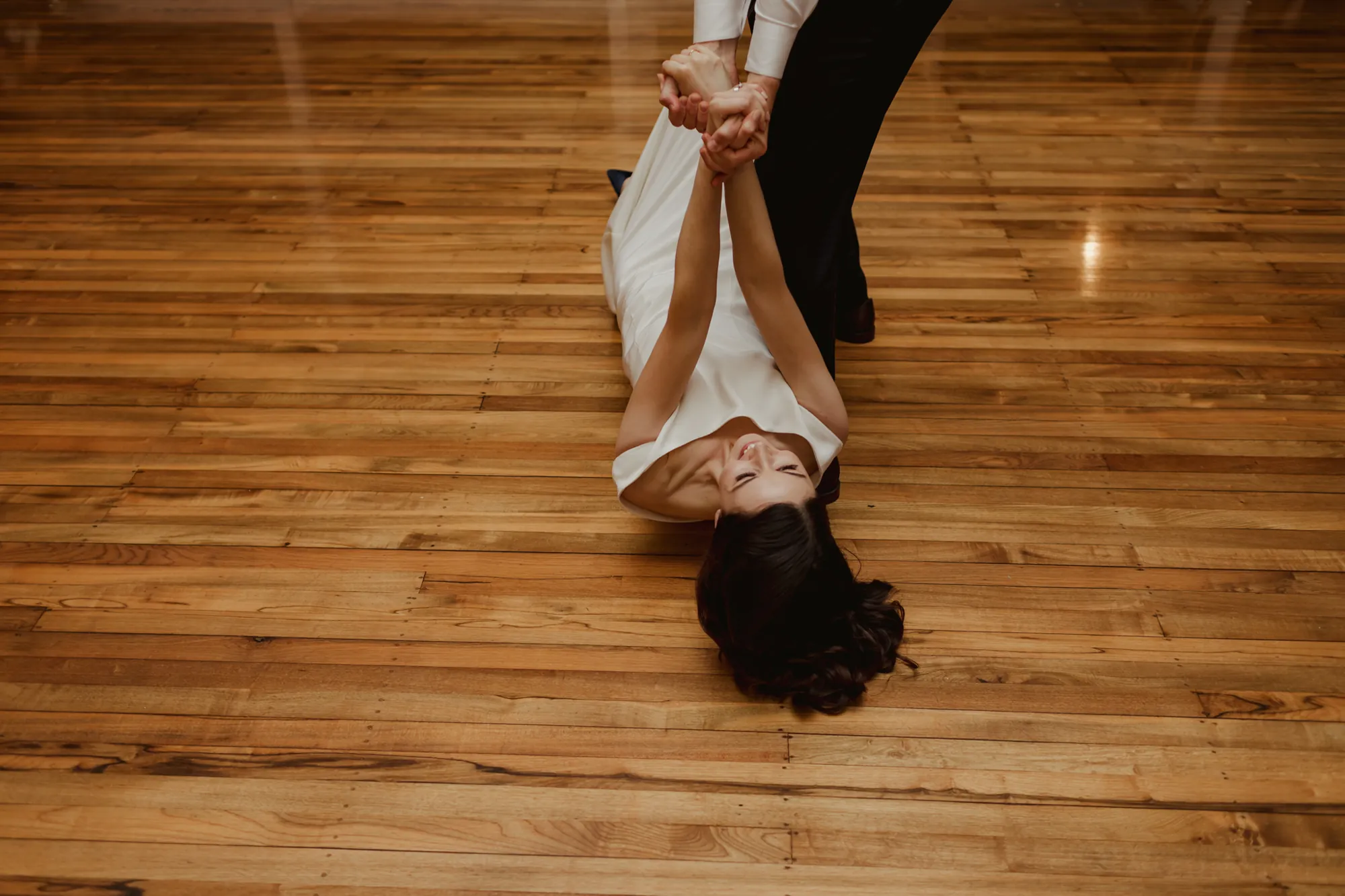 Dylan dipping Lily low to the timber dance floor during their first dance