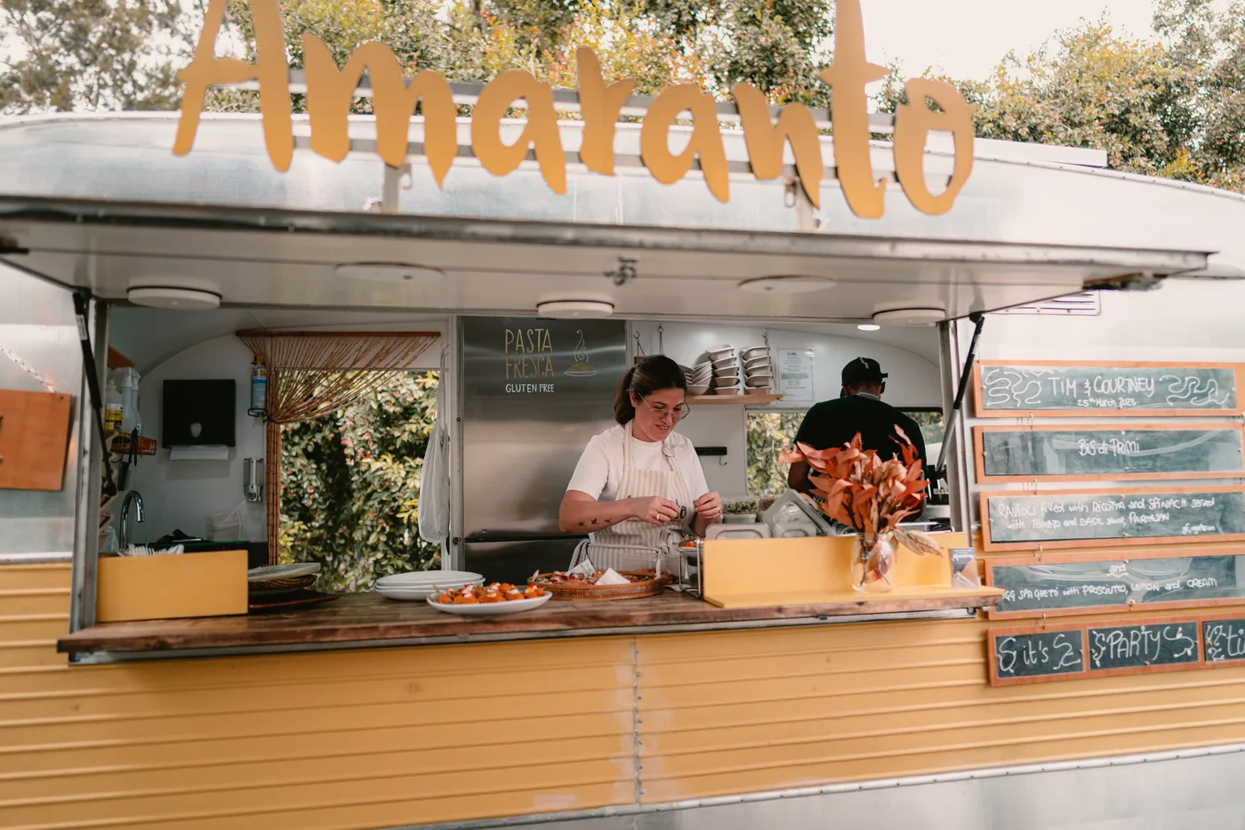 Luisa serving fresh gluten-free pasta from the Amaranto caravan at Tim and Courtney's wedding at Nocton Woolshed, Tuakau