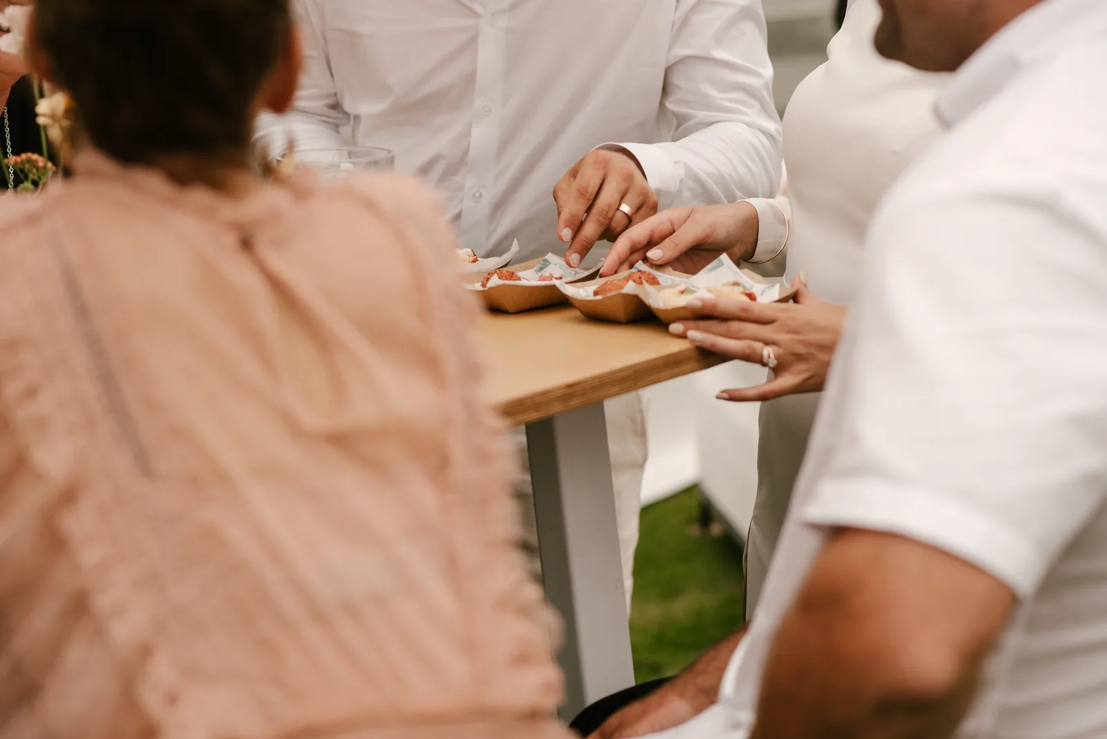 Food being served at high tables at Sandi and Ryan's wedding reception at Whangaumu Bay, Tutukaka Coast